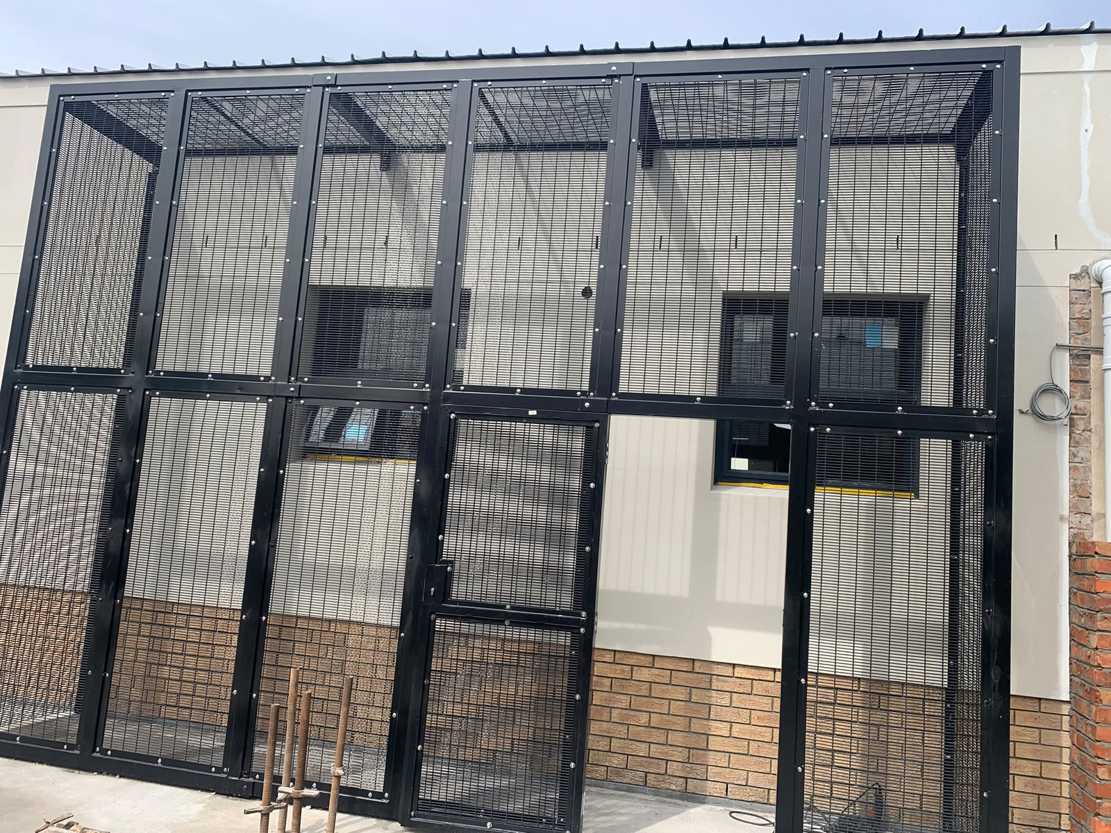 Reinforced security cage and access gate installation